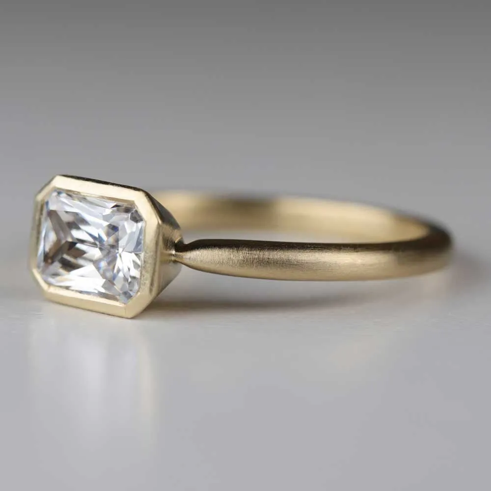 Emerald Cut East-West Bezel Solitaire Engagement Ring