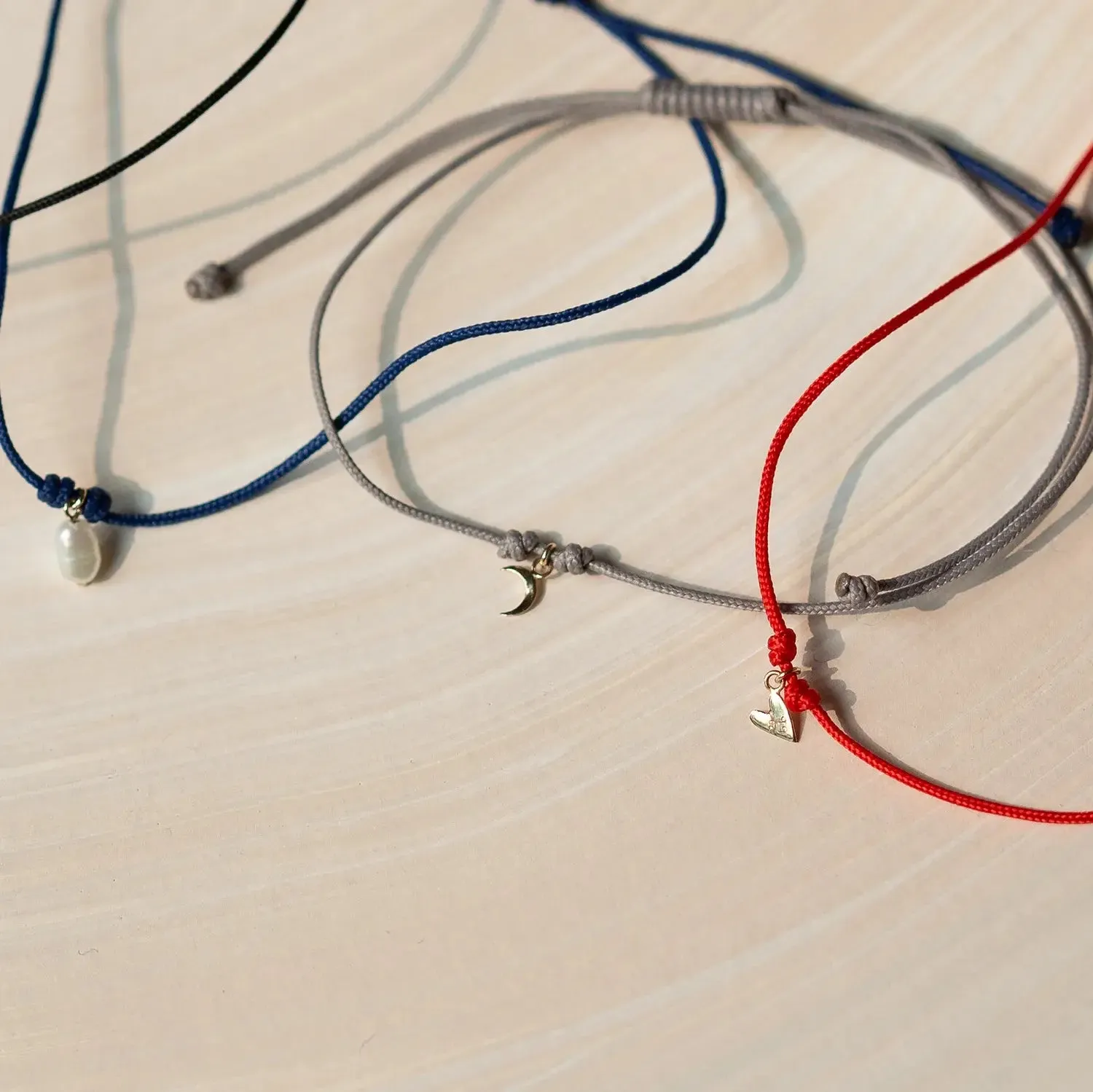 The deep love contemplation cord bracelet - 10k yellow gold, red cord